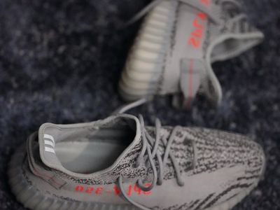 Close up of sports shoes on a grey surface.